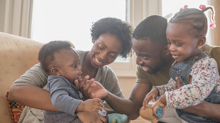 mother and father and kids on a couch