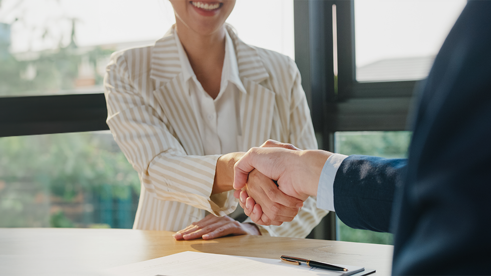Signing a business loans, two people shaking hands