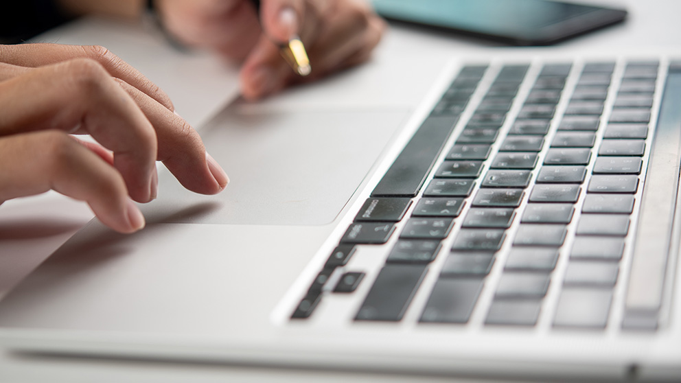 Closeup of a person using a tackpad on a laptop
