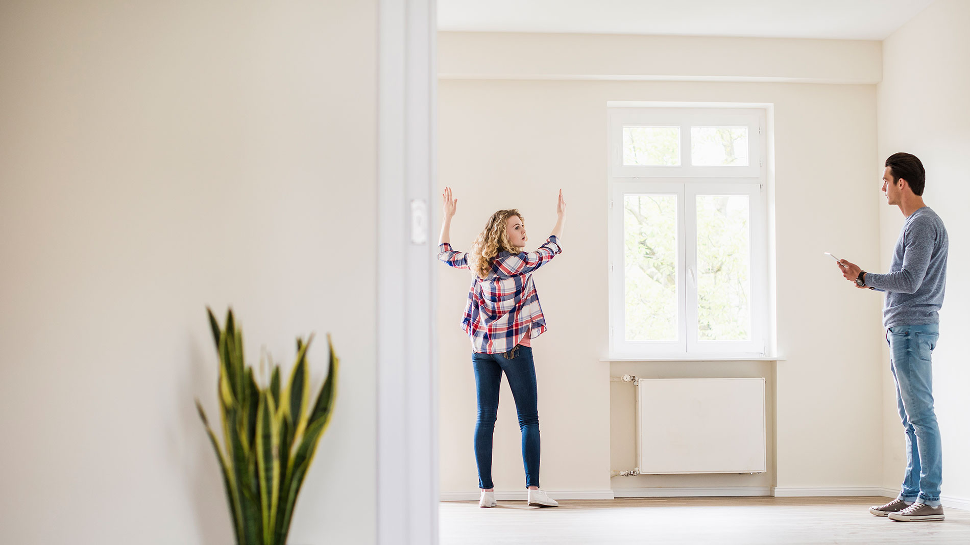 Young couple decorating their new apartnment.