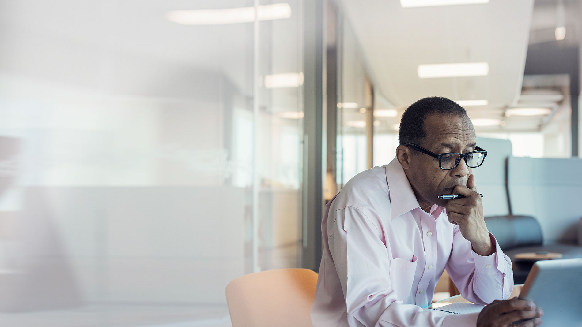 Man working on his tablet in his office.