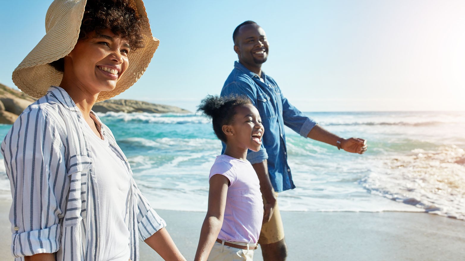 Family gathered along a lakefront shoreline with water and outdoor scenery, representing a Wisconsin summer bucket list moment.