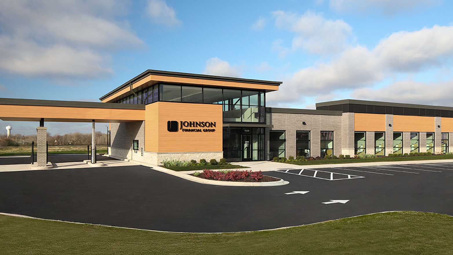 Front exterior of a single-story Johnson Bank with red brick walls, a covered entrance, and large cream-colored columns and trim.