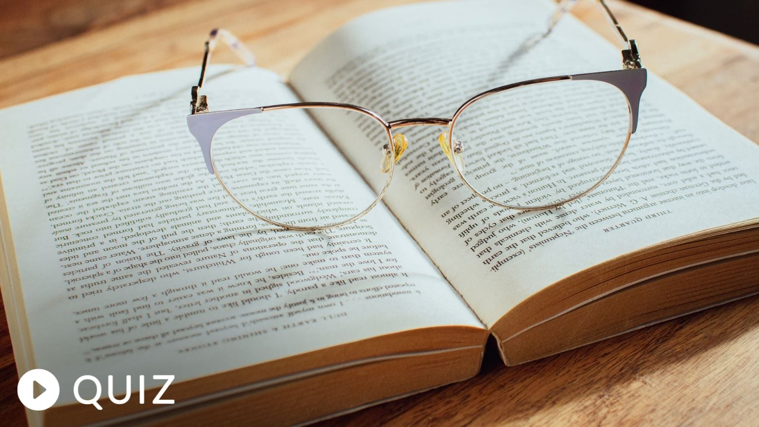 glasses resting on the center of an open book
