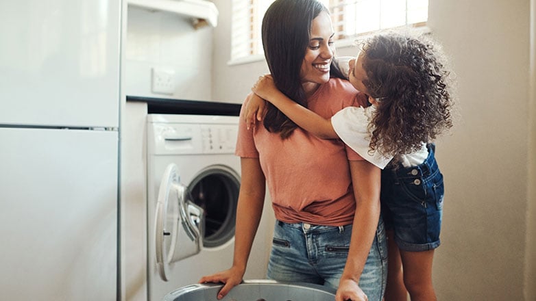 Mom doing laundry with daughter