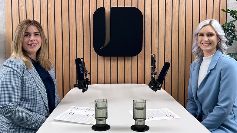 Alexis Wolff and Sam Kolb sitting a podcast studio.