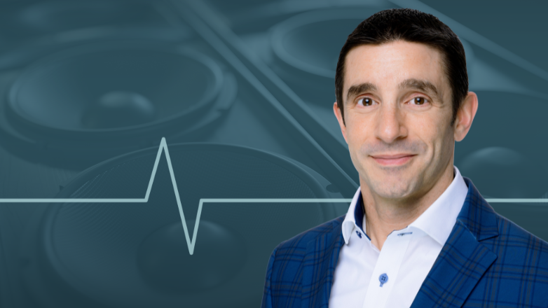Dominic Ceci's headshot over an image of speakers.