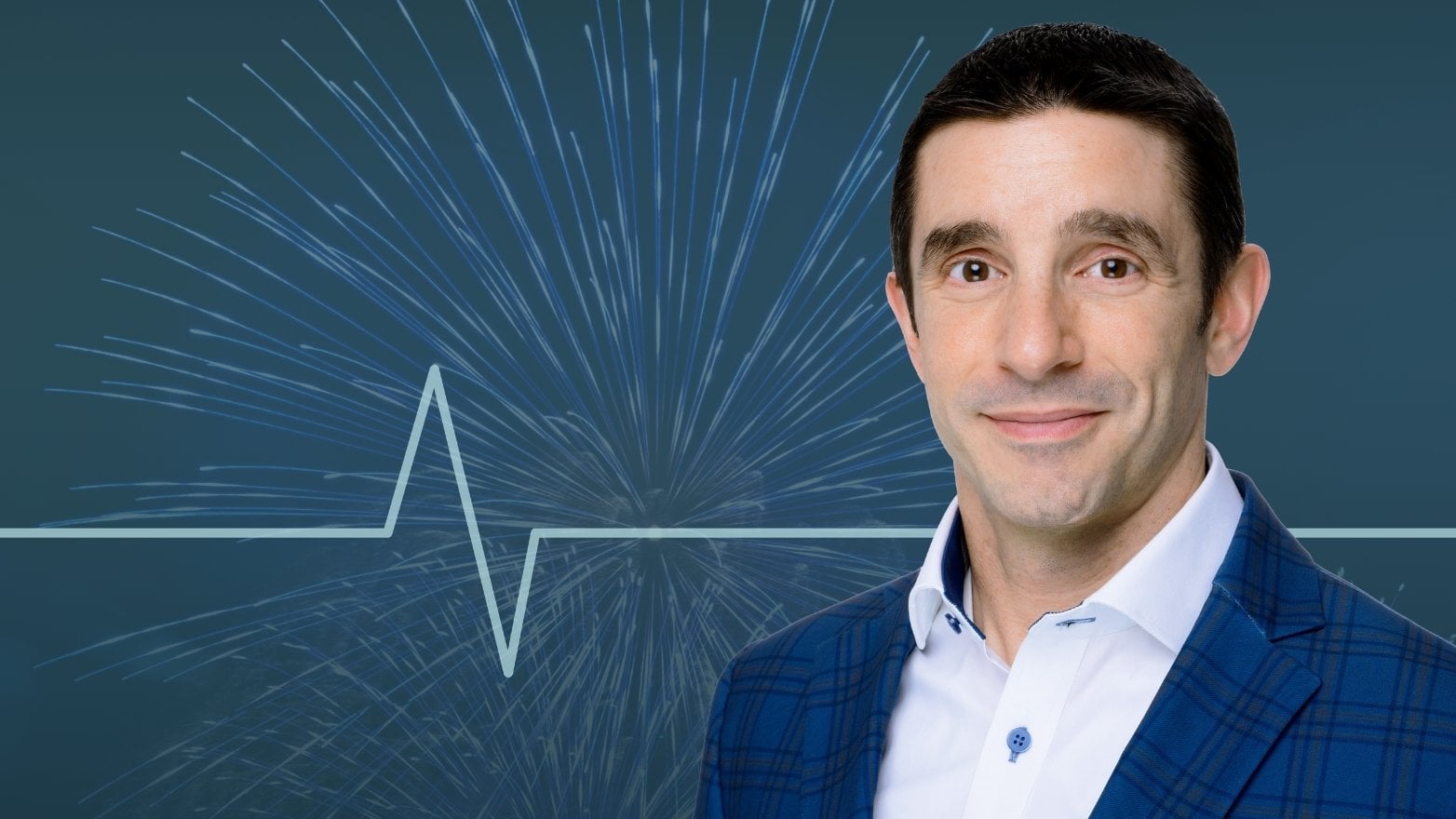 Professional headshot of a man in a blue suit jacket smiling at the camera, with blue fireworks and a heartbeat-style line graphic in the background.