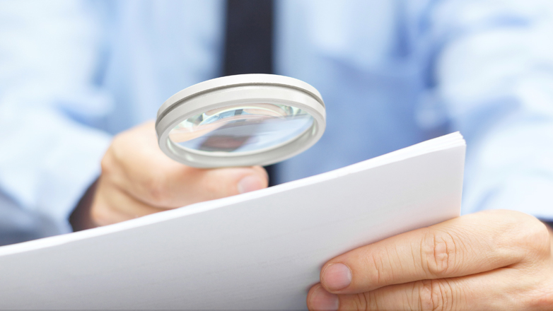 man holding magnifying glass