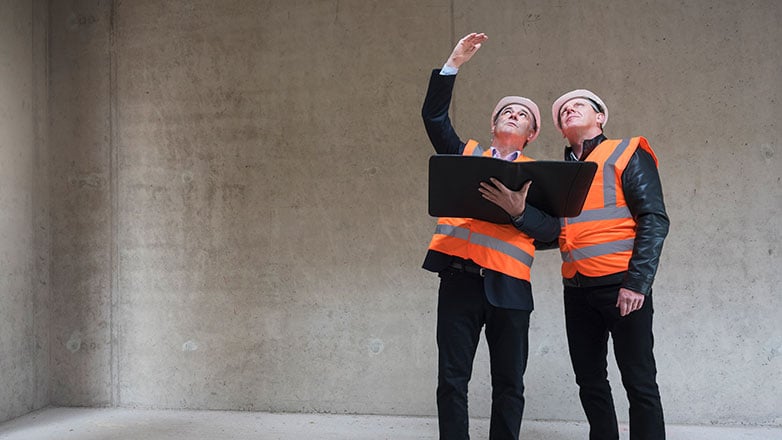 Buisiness owner and architect checking on new building plans.