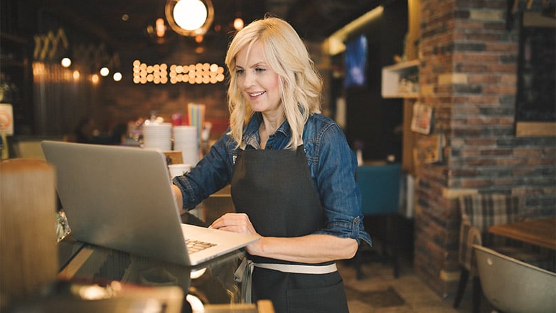 cafe shop owner using laptop