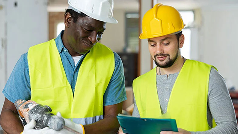 Construction workers review the day's itinerary at the construction site.