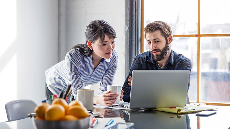 Couple reviewing their loan options on their laptop.
