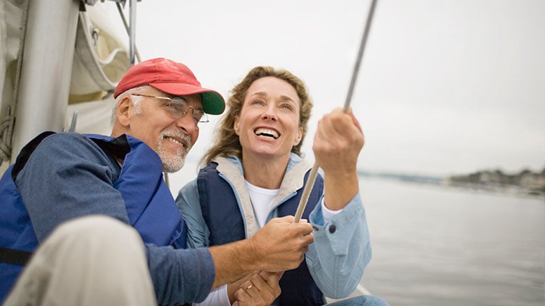 Retired couple on sailboat enjoying their retirement.