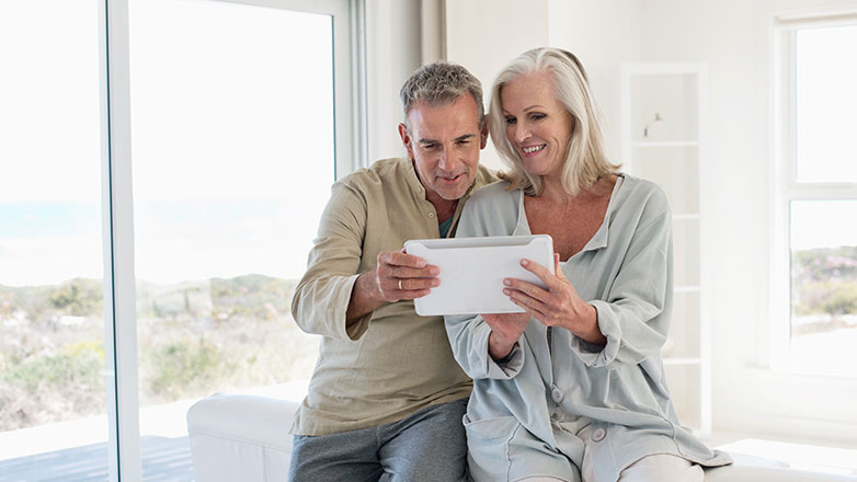 Grandma and grandpa talking to their family on ipad.