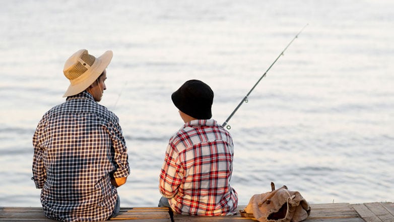 Father and son take a fishing trip to the lake.