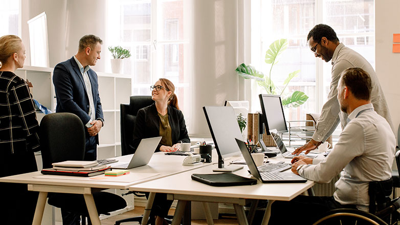 Group of coworkers in an office working together on a project.