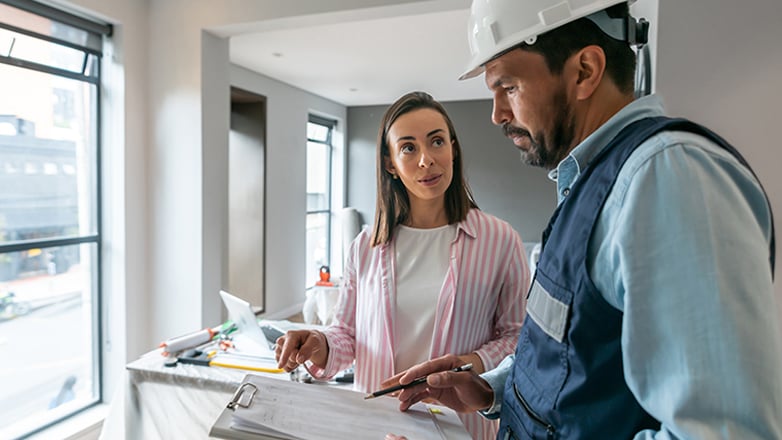 Homeowner talks to contractor about her plans for her house construction.