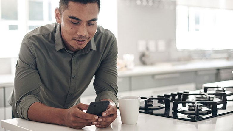 Man reviews his retirement plan options on his smartphone.