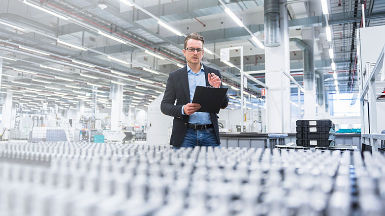 Man in warehouse taking product inventory.