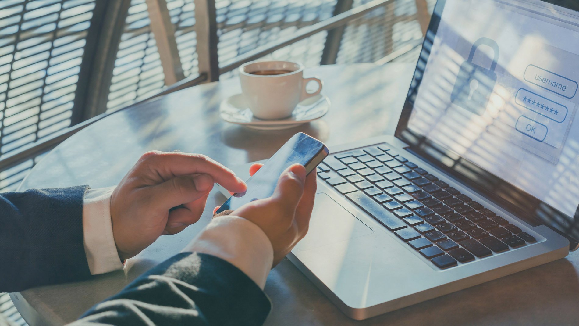 man using phone and laptop.