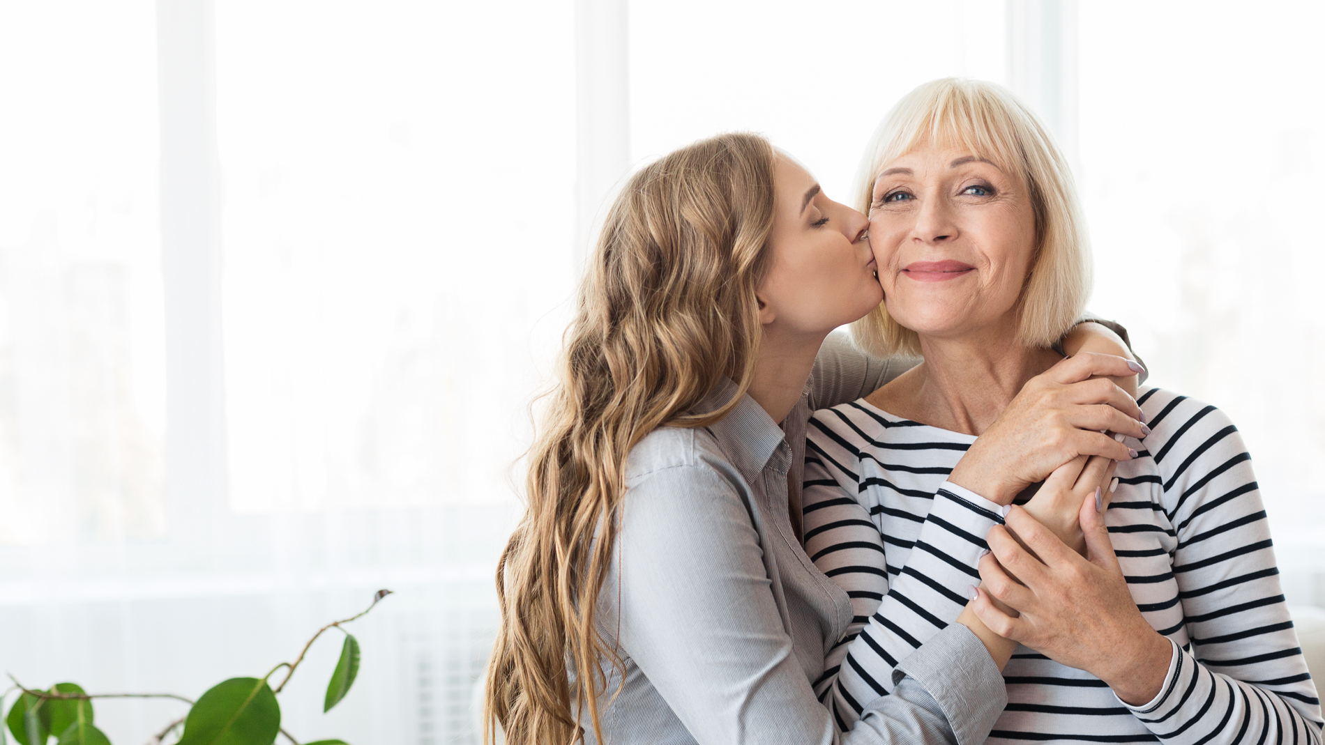 daughter embracing and kissing mother