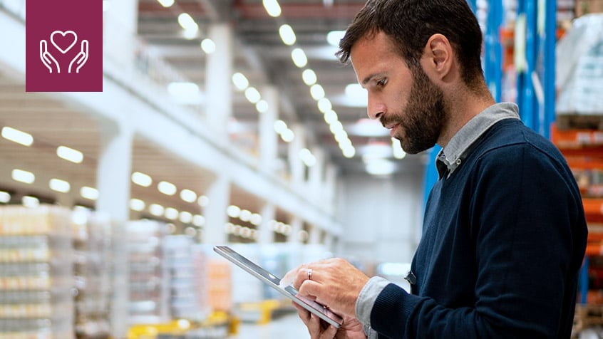 Business-man-looking-at-tablet-in-warehouse