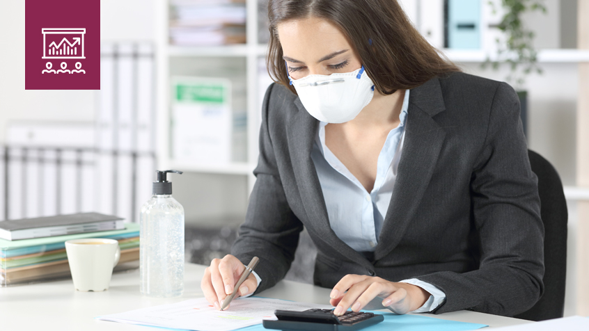 business woman wearing a mask and using a calculator