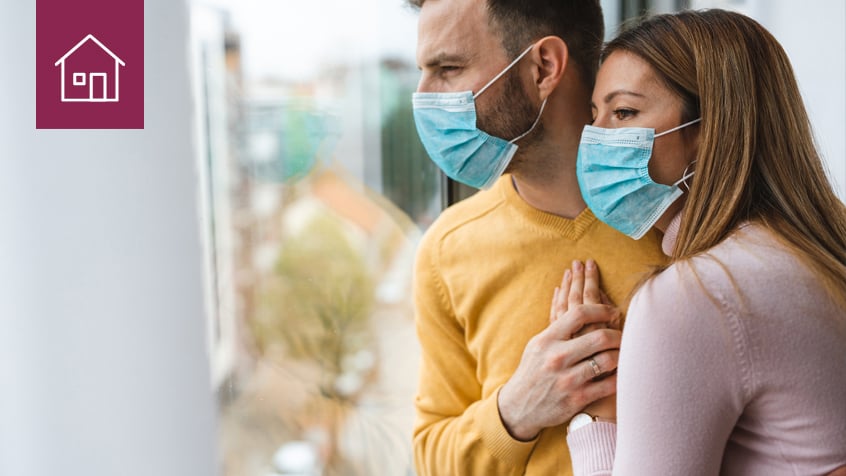couple wearing masks with mortgage icon