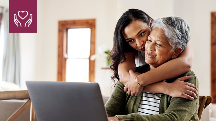 granddaughter hugging grandmother from behind
