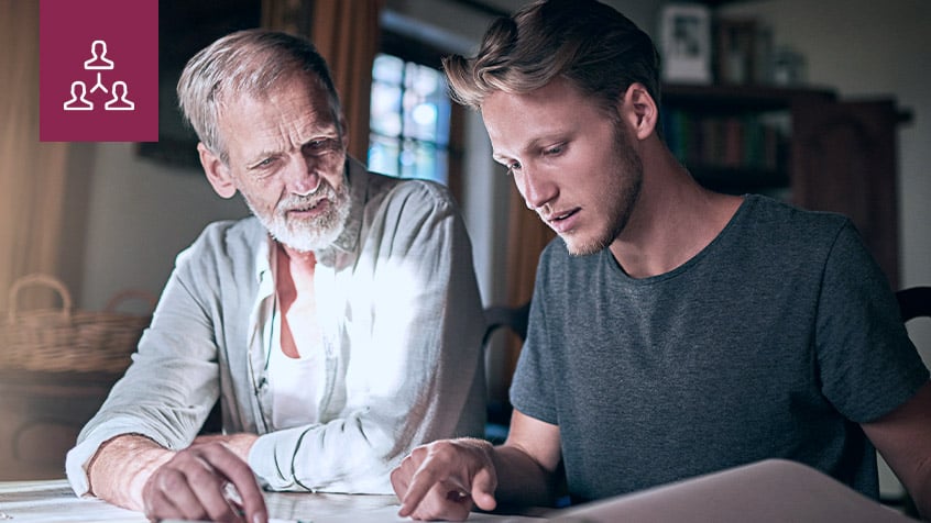 Father showing son how to do business paperwork.