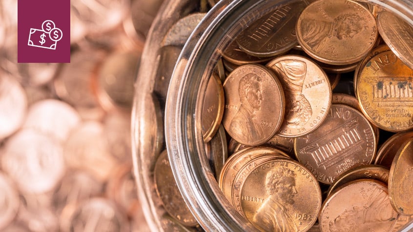 close up of coins in a glass jar