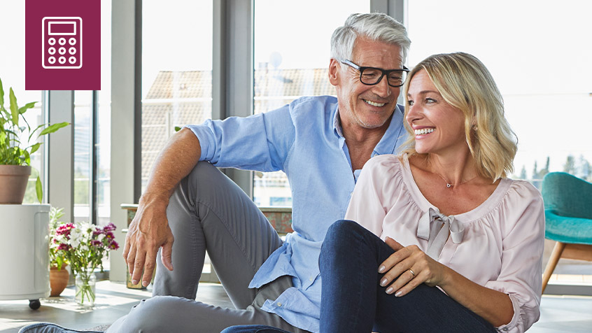Mature couple sitting together looking out a city window.