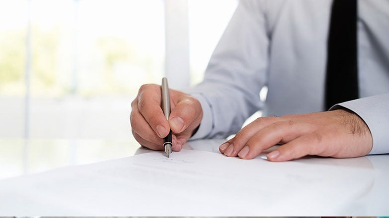 hand signing signature on official document