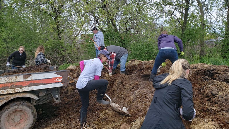 service day people shoveling dirt