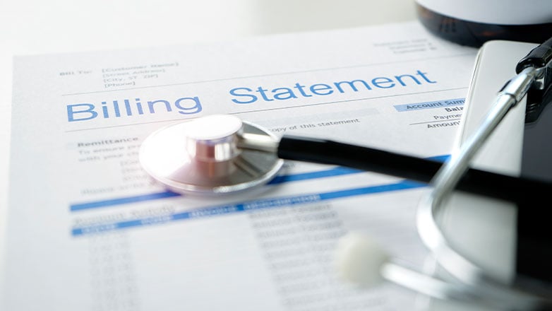 stethoscope laying on medical billing statement
