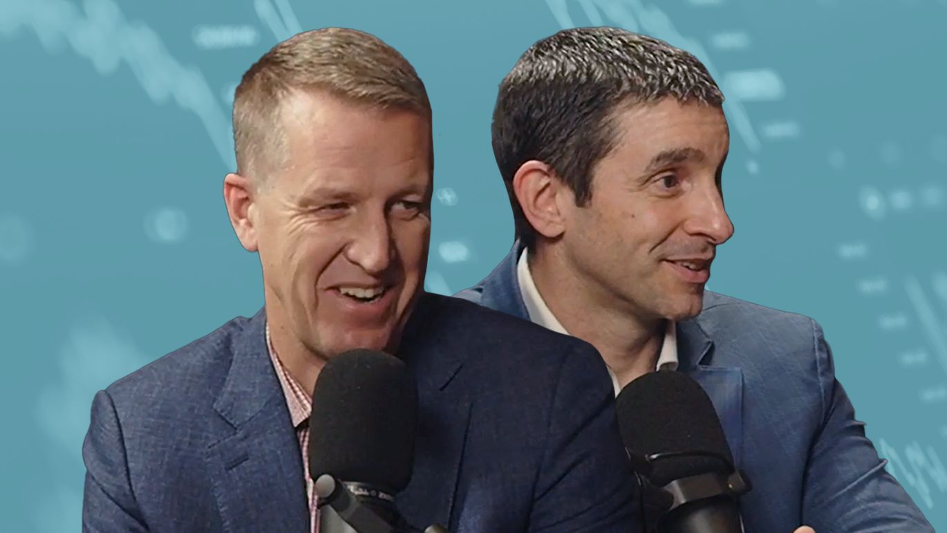 Two people speaking into microphones in a podcast studio with financial chart graphics in the background.