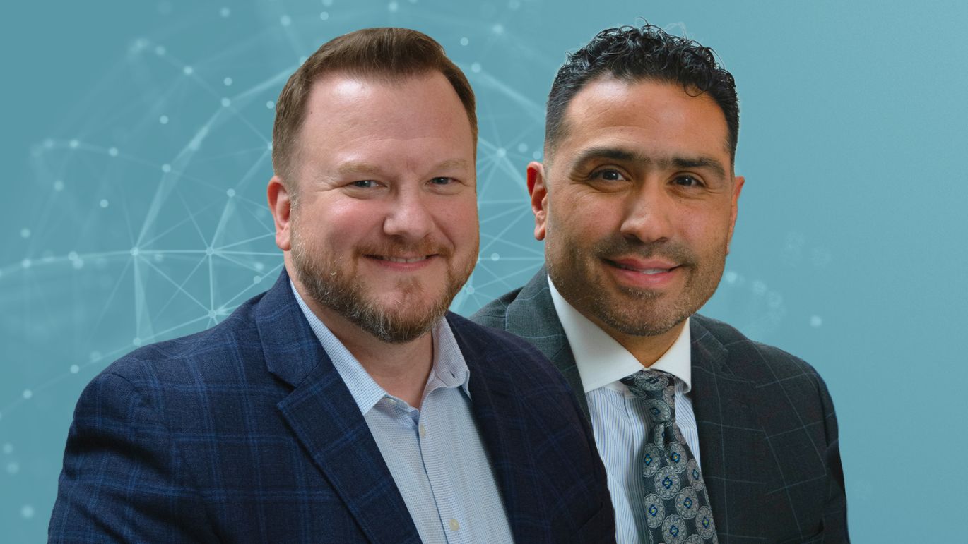 Two people in business attire posed against a blue-toned digital network graphic.