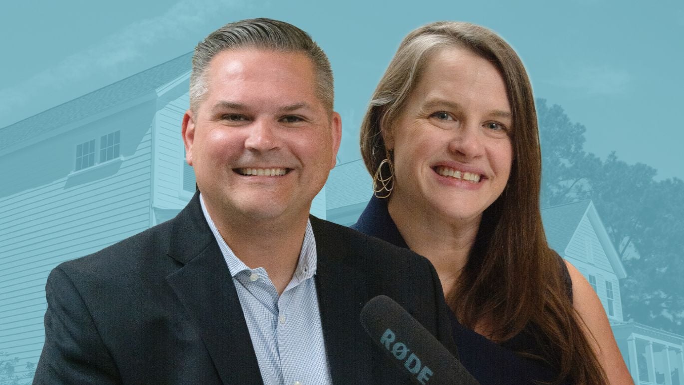 Two people smiling in front of a blue-toned residential home background with a podcast microphone visible.