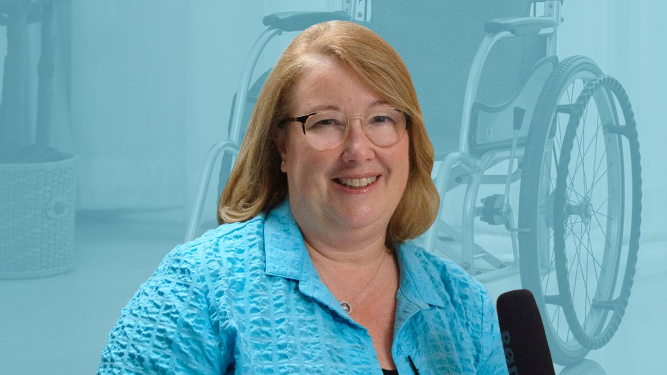 Person posed against a blue-toned background featuring a wheelchair.