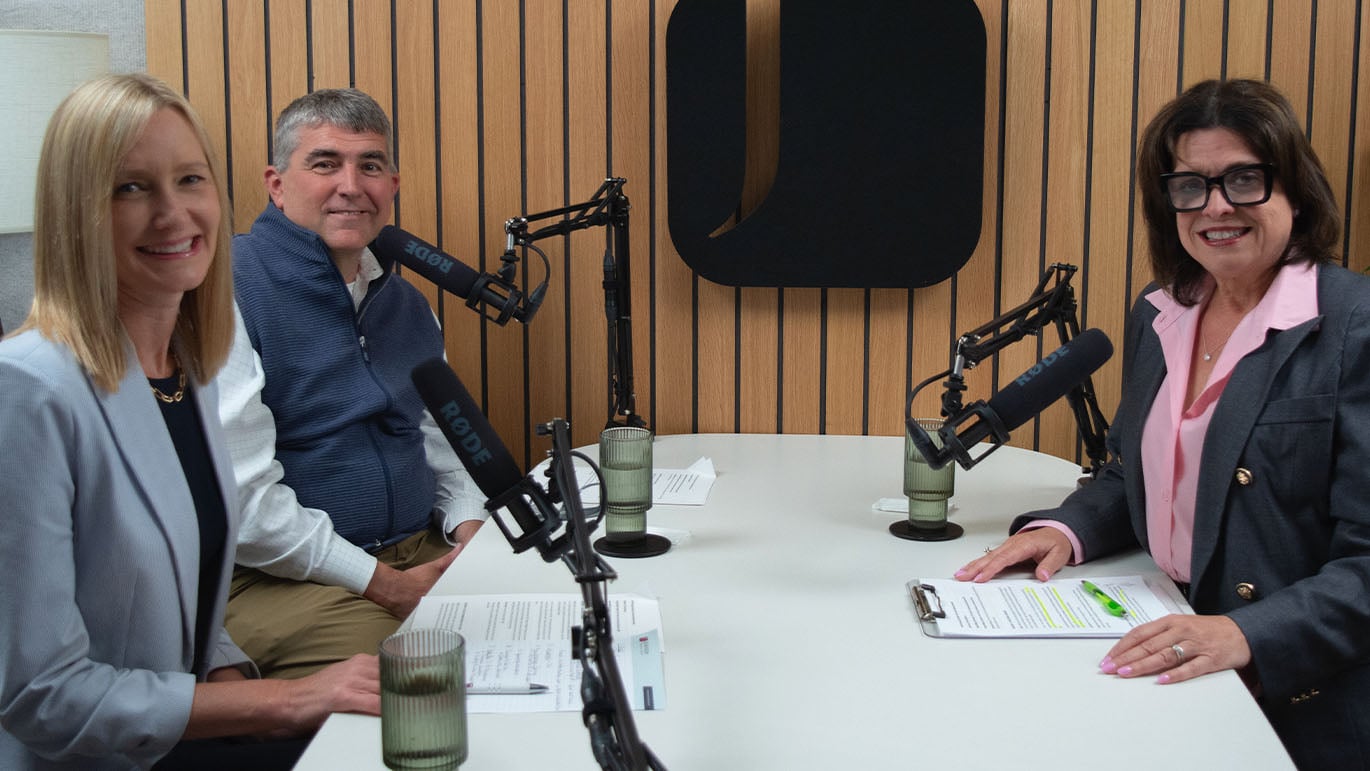 Three financial professionals sit at a podcast recording table with microphones, discussing wealth planning strategies. The image supports a conversation about the Great Wealth Transfer and how families can prepare to pass wealth, values, and financial confidence to future generations.