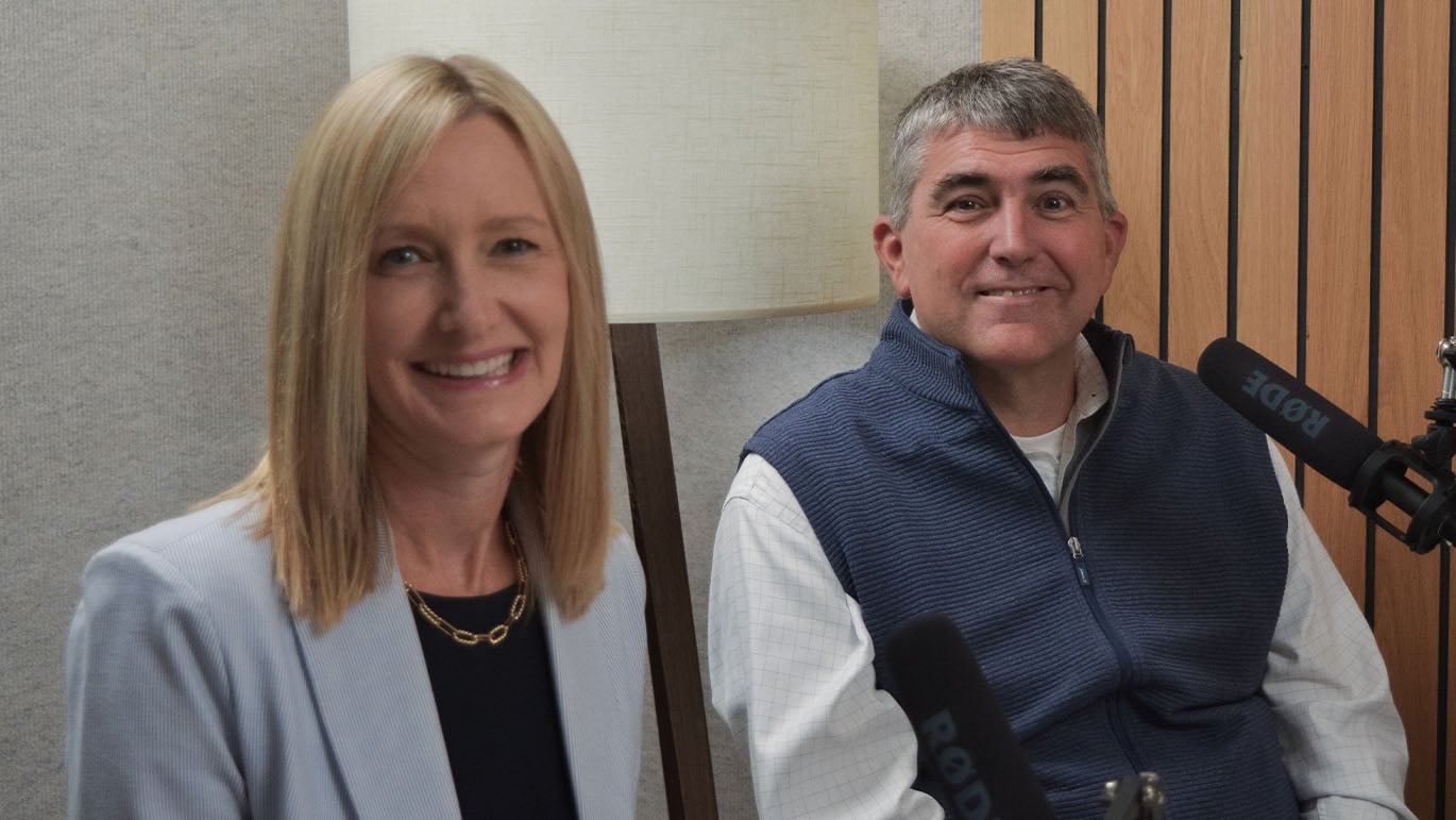 financial professionals sit at a podcast recording table with microphones, discussing wealth planning strategies. The image supports a conversation about the Great Wealth Transfer and how families can prepare to pass wealth, values, and financial confidence to future generations.