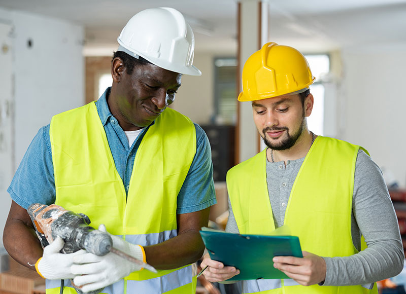 Construction workers review the day's itinerary at the construction site.