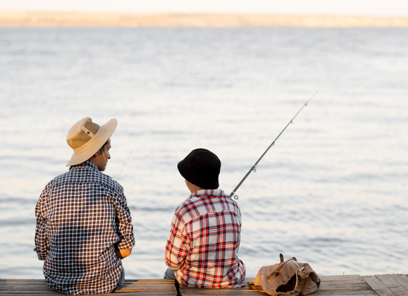Father and son take a fishing trip to the lake.