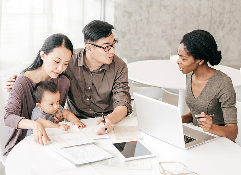 Financial advisor meets with a young family to discuss their portfolio.