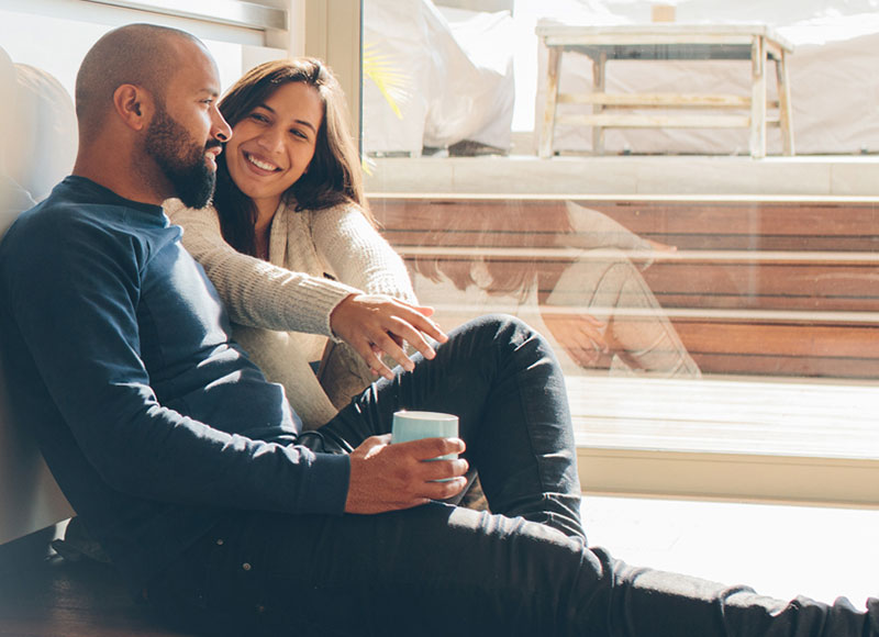 Couple sitting on kitchen floor and dreaming together.