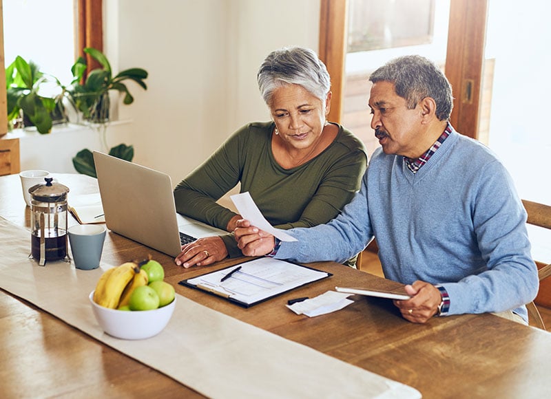 An older couple reviews their financial documents together.
